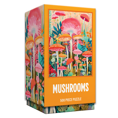 A rectangular box containing the ROSEART Vertical Visions Mushrooms 500 Piece Jigsaw Puzzle, featuring colorful illustrated mushrooms and plants, with “Mushrooms” displayed on the front.