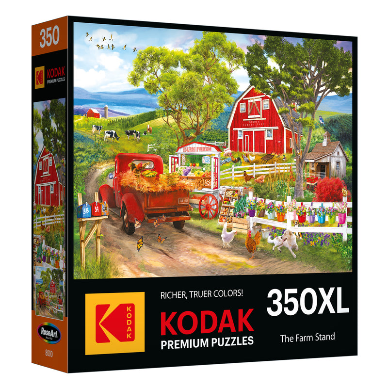 The ROSEART - KODAK PREMIUM - FARM STAND 350 Piece Jigsaw Puzzle features a vibrant farm scene with a red truck, barn, cows, and bustling market stand. With "Richer, Truer Colors," it offers an engaging puzzle-solving experience.