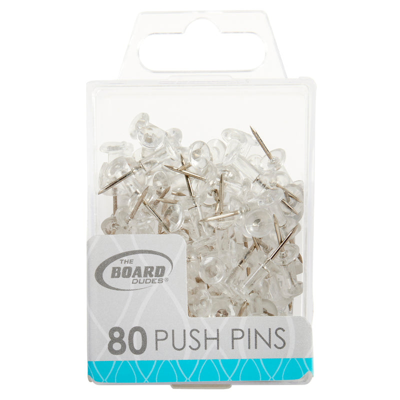 A clear plastic container labeled "Board Dudes PUSH PINS - Clear 80 Count" from "The Board Dudes" brand, filled with silver metal push pins with transparent plastic heads.