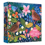 The ROSEART Soft Touch Strawberry Thief 1000 piece jigsaw puzzle features an illustrated scene of two birds, butterflies, pink flowers, and strawberries on a blue background, inspired by the classic Strawberry Thief motif.