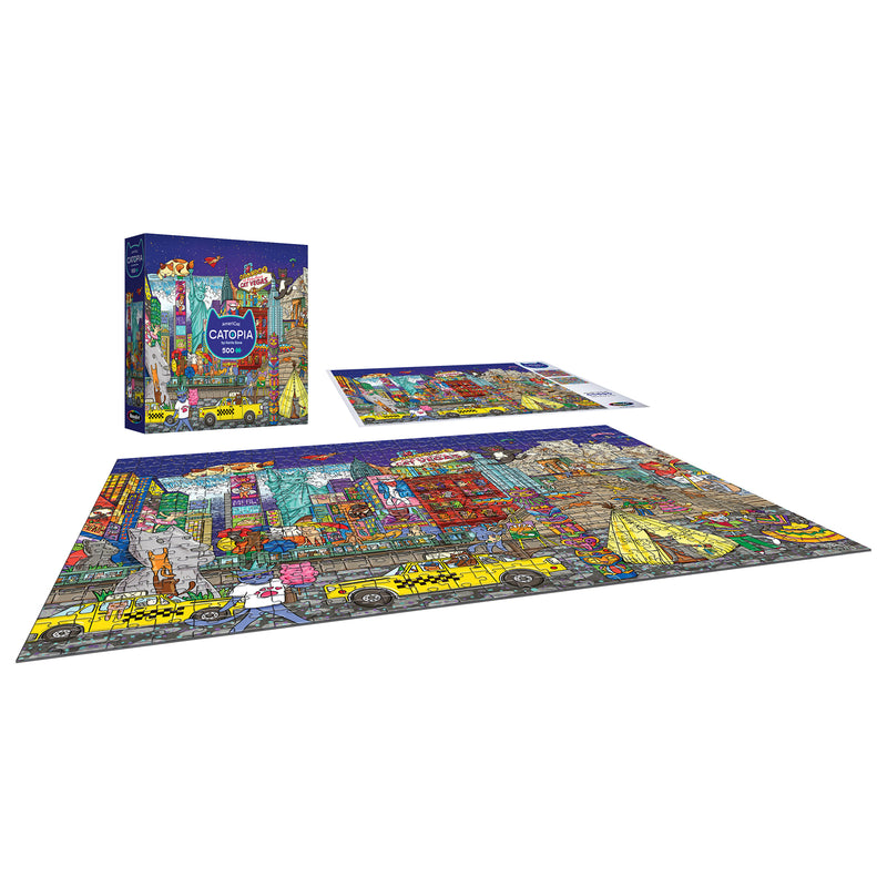 A finished ROSEART-CATOPIA-AMERICAT-500 PIECE JIGSAW PUZZLE with a vibrant city of cats and taxis is shown next to the puzzle box and unassembled pieces.