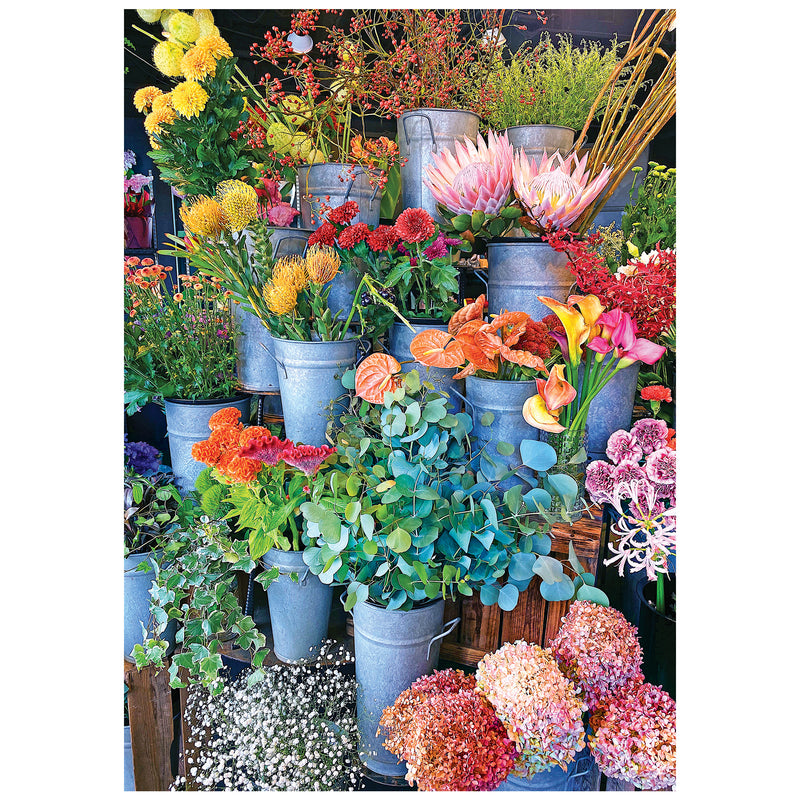Colorful flowers and greenery fill metal buckets on tiered shelves, just like the vibrant scene featured in the ROSEART-KODAK CAMERA TO CANVAS-COLORFUL FLOWERS 500-piece jigsaw puzzle.
