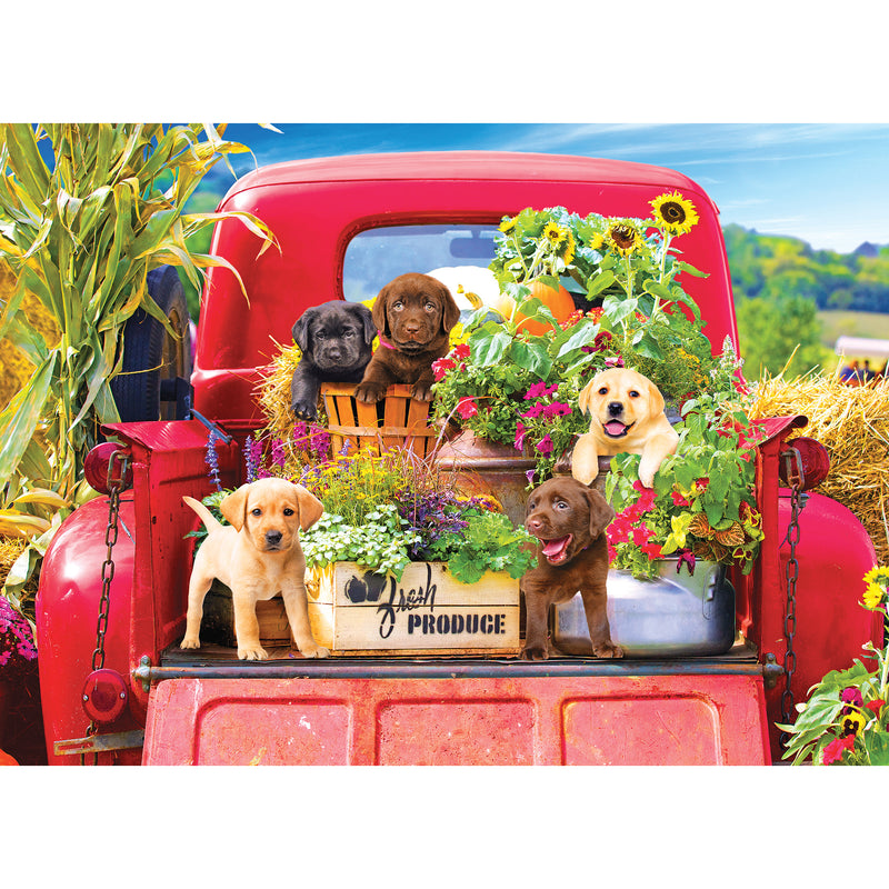Five puppies surrounded by flowers and plants sit on the back of a red truck, which also carries a crate labeled "Fresh Produce" and hay bales, depicted in the RoseArt - Kodak Premium - Stowaways - 1000 Piece Jigsaw Puzzle.