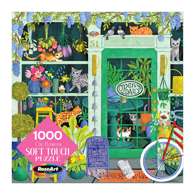 Illustrated puzzle box showing a garden scene with various cats among plants and flowers. The puzzle is labeled "RoseArt-Soft Touch-Cat Flowers-1000 Piece Jigsaw Puzzle," includes 1000 pieces, and is produced by RoseArt.