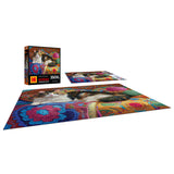 A vibrant 300-piece ROSEART KODAK PREMIUM jigsaw puzzle showcases a knitting kitten on a colorful background, displayed with its box and scattered pieces.