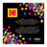 A colorful array of puzzle pieces surrounds a box featuring the Kodak logo. Text describes RoseArt-Kodak Premium-Club Pool-1000 Piece Jigsaw Puzzle as vivid, easy to handle, and with minimal dust. RoseArt branding is at the bottom.