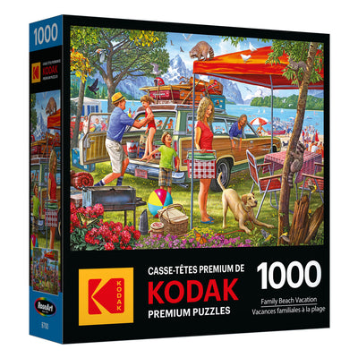 A 1000-piece RoseArt-Kodak Premium-Family Beach Vacation-1000 Piece Jigsaw Puzzle shows an illustrated scene of a family enjoying a day at the beach. The box features bright colors and playful outdoor activities.