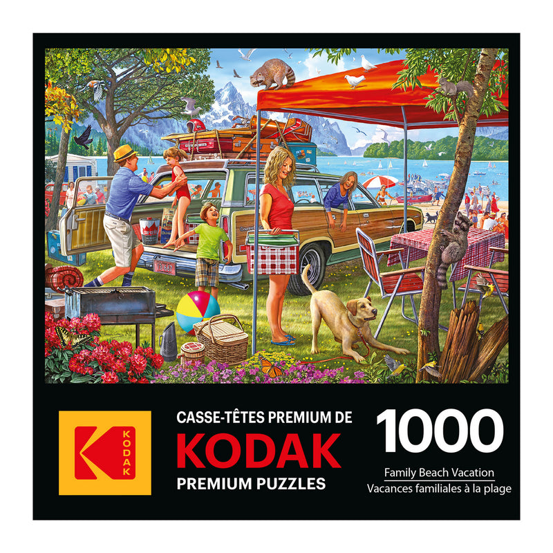 The image shows the box art of a RoseArt-Kodak Premium-Family Beach Vacation-1000 Piece Jigsaw Puzzle, depicting people setting up for a beach day with picnic tables, camping gear, and a lake in the background.