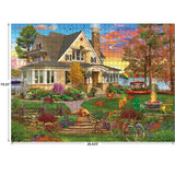 The Cra-Z-Art RoseArt Kodak Cork - Lakeside Home 1000 Piece Jigsaw Puzzle captures a cozy lakeside home scene with a lush garden, relaxing cats and dogs, a bicycle, and a picturesque sunset sky. It measures 19.25 inches by 26.625 inches.