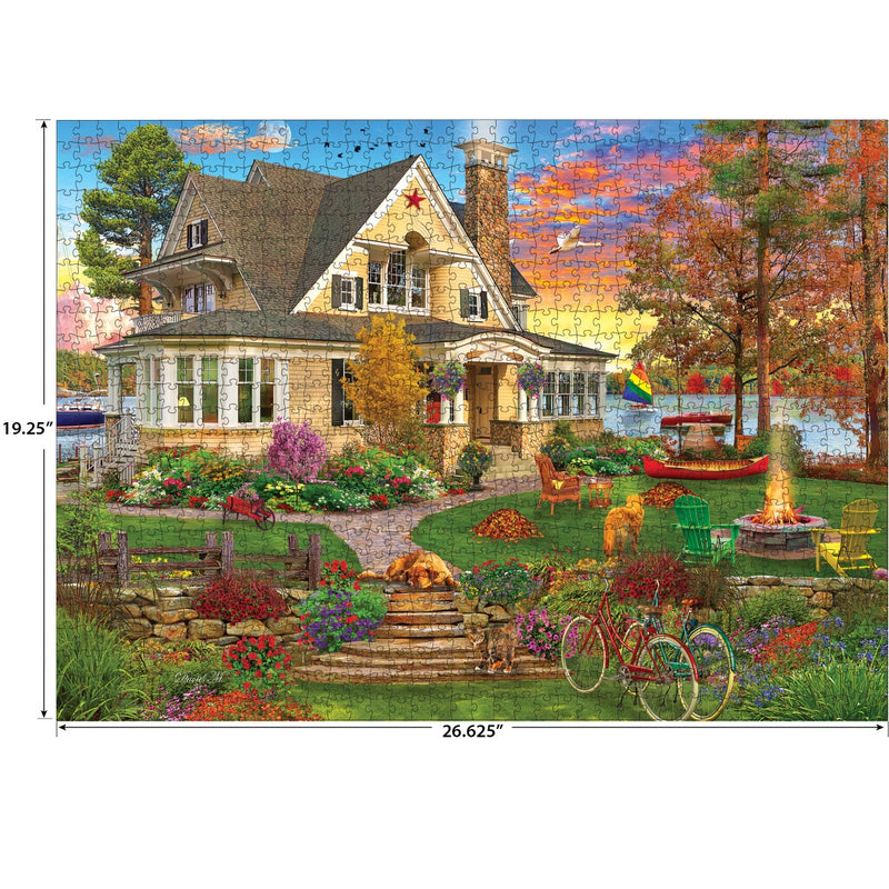 The Cra-Z-Art RoseArt Kodak Cork - Lakeside Home 1000 Piece Jigsaw Puzzle captures a cozy lakeside home scene with a lush garden, relaxing cats and dogs, a bicycle, and a picturesque sunset sky. It measures 19.25 inches by 26.625 inches.