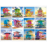 Experience the charm of 12 vibrant lifeguard huts on a serene beach, each uniquely crafted with diverse shapes and lively colors in the RoseArt - Kodak Premium - Lifeguard Huts - 350 piece jigsaw puzzle. A clear sky with a few clouds and a calm sea in the background complete this picturesque scene.