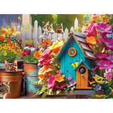 Witness a colorful garden scene in the 350-piece jigsaw puzzle "Songbirds 2" by RoseArt and Kodak Premium. This vibrant illustration features a lively birdhouse amidst flowers, butterflies, and potted plants. Multiple cats can be spotted lounging among the plants or perched on a white picket fence, while songbirds add a melodious touch to this picturesque view.
