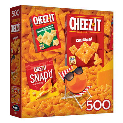 The ROSEART - SNACK ASSORTMENT - CHEEZ ITS includes a delightful range of Cheez-It snacks like Original, White Cheddar, and Snap'd, paired with a 500-piece jigsaw puzzle featuring a smiling cracker in sunglasses on cheese.
