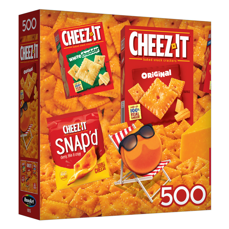 The ROSEART - SNACK ASSORTMENT - CHEEZ ITS includes a delightful range of Cheez-It snacks like Original, White Cheddar, and Snap'd, paired with a 500-piece jigsaw puzzle featuring a smiling cracker in sunglasses on cheese.