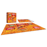 The ROSEART - SNACK ASSORTMENT - CHEEZ ITS 500-piece jigsaw puzzle showcases various Cheez-It packaging designs, completed on a flat surface with the box and lid beside it.