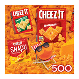 The ROSEART Snack Assortment 500-piece jigsaw puzzle features Cheez-It crackers in Original and Snap'd packs, complemented by a cheese wedge and a cartoon cheese circle on a deck chair, offering a delightful and fun cheesy experience.