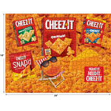 The ROSEART - SNACK ASSORTMENT features Cheez-It products like Original, White Cheddar, and Snap'd in a 500-piece jigsaw puzzle. The Cheez-It mascot lounges with sunglasses alongside the text: "Want It. Need It. Cheez-It." Enjoy this delightful creation!.