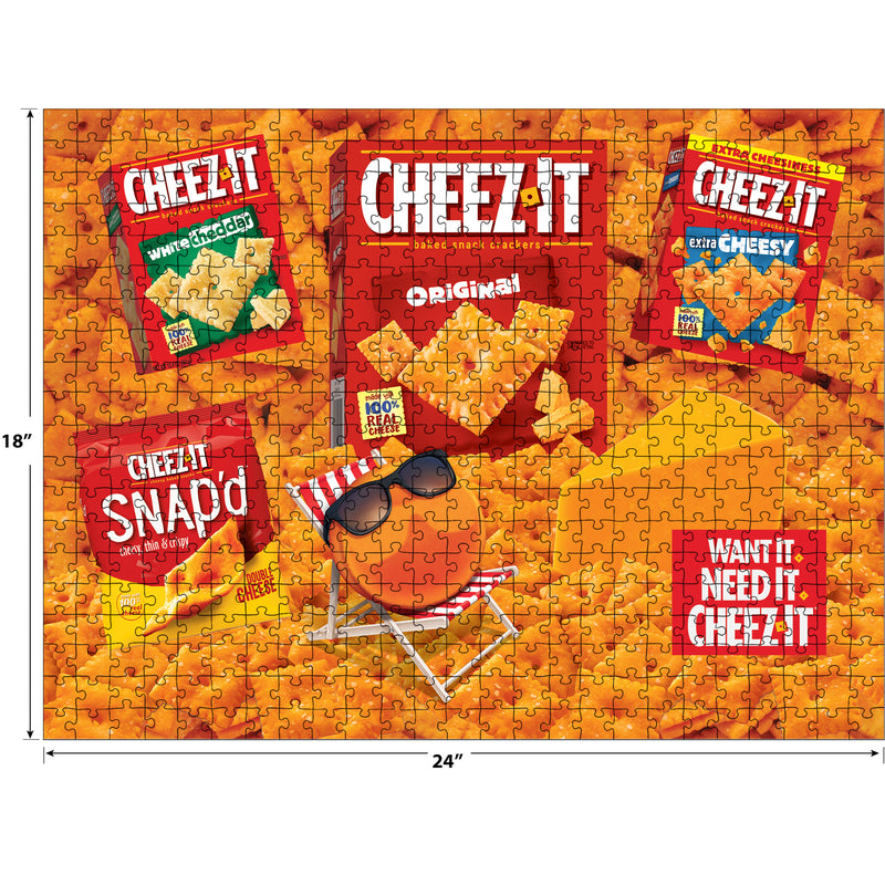 The ROSEART - SNACK ASSORTMENT features Cheez-It products like Original, White Cheddar, and Snap'd in a 500-piece jigsaw puzzle. The Cheez-It mascot lounges with sunglasses alongside the text: "Want It. Need It. Cheez-It." Enjoy this delightful creation!.