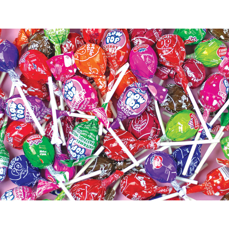A colorful ROSEART snack assortment featuring various Tootsie lollipop flavors in clear wrappers, scattered randomly like a 500-piece jigsaw puzzle.