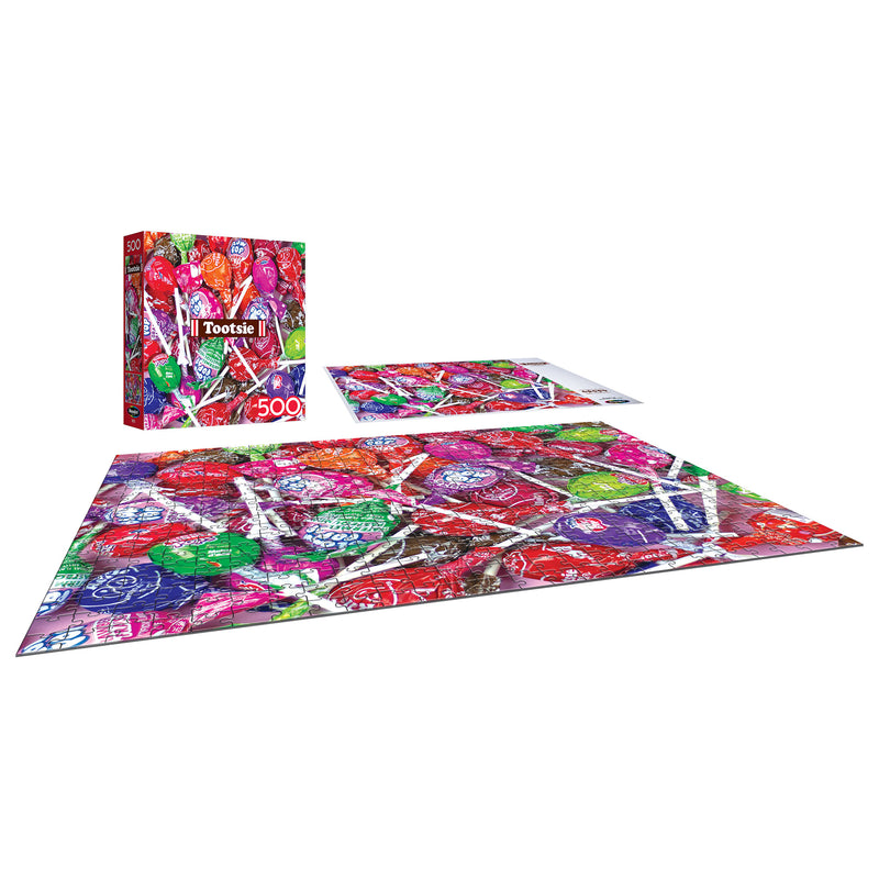 The 500-piece jigsaw puzzle from ROSEART's "SNACK ASSORTMENT - TOOTSIE" features vibrant lollipops and comes in a matching "Tootsie" themed box.