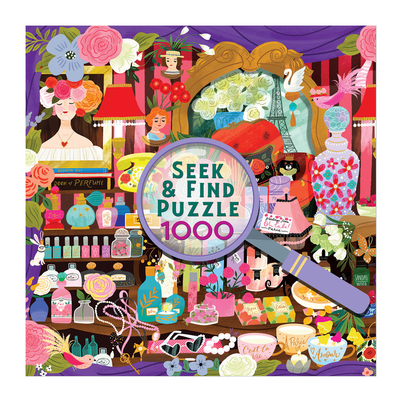 A colorful illustration of a bustling vanity scene with flowers, trinkets, and a magnifying glass highlights ROSEART - SEEK & FIND - PARIS PERFUME SHOP, a charming 1000 piece jigsaw puzzle inspired by an elegant Paris perfume shop.