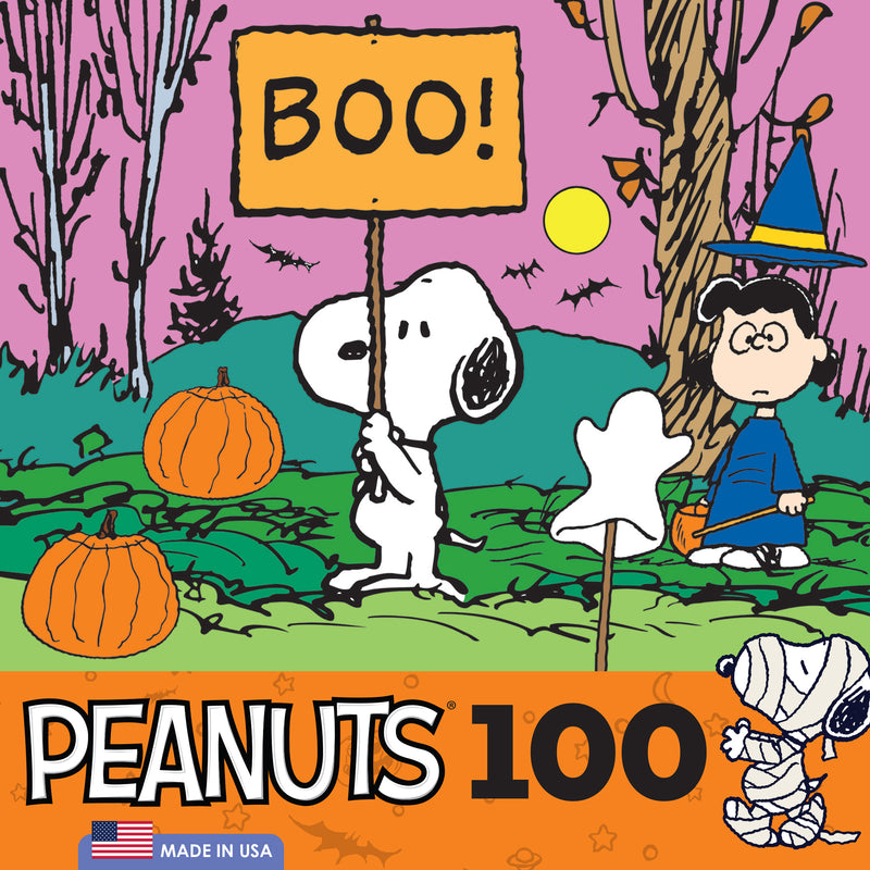 Snoopy holds a "Boo!" sign while wearing a Halloween costume. Lucy stands nearby in a witch outfit. Pumpkins and a ghost decoration are in the background. Text reads "RoseArt - Peanuts Halloween - Boo! - 100 Piece Jigsaw Puzzle" with a US flag.