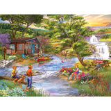 Three children and a dog by a stream near a log cabin. One child is fishing, two are playing near a garden, and picnic table is set up nearby. A waterfall and mountains are in the background. This scene can be experienced through the RoseArt - Chris Bigelow - Fishing from the Banks - 1000 Piece Jigsaw Puzzle.
