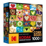 RoseArt - Kodak Cork - Love is Everywhere - 1000 Piece Jigsaw Puzzle box featuring various colorful heart images on a cork board background, with a "1000" piece count and an included puzzle poster.