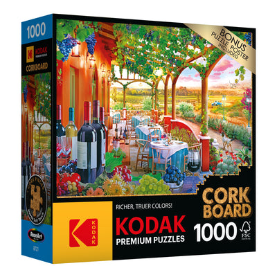 RoseArt - Kodak Cork - Wine Country - 1000 Piece Jigsaw Puzzle box featuring an image of a Mediterranean-style outdoor cafe with wine bottles and scenic vineyard background. The puzzle has 1000 pieces and includes a bonus poster.