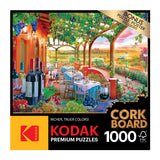Box for a 1000-piece RoseArt - Kodak Cork - Wine Country - 1000 Piece Jigsaw Puzzle, featuring an outdoor dining scene with wine bottles, grapes, and a scenic vineyard in the background.
