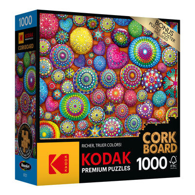 RoseArt - Kodak Cork - Mandala Stones - 1000 Piece Jigsaw Puzzle with a colorful circular pattern and corkboard backing. Box labeled "Kodak Premium Puzzles," "Richer, Truer Colors!," and "Bonus Puzzle Poster Inside.