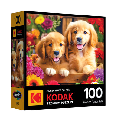 The ROSEART KODAK PREMIUM Golden Puppy Pals 100-piece jigsaw puzzle features two golden puppies among colorful flowers, with "Golden Puppy Pals" on the box front.