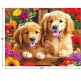 Two Golden Puppy Pals with open mouths sit in a basket among colorful flowers on this ROSEART KODAK PREMIUM GOLDEN PUPPY PALS 100-piece jigsaw puzzle, measuring 10 x 13 inches.