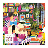 The ROSEART - MY HAPPY PLACE - READING NOOK - 750 PIECE JIGSAW PUZZLE depicts a woman in a cozy pink chair with a blanket and her cat, surrounded by books, plants, and string lights—ideal for those who love immersing in stories or completing jigsaw puzzles.