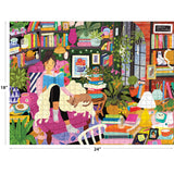 A vibrant illustration of a woman reading in a cozy nook with books, plants, and a cat on a chair, evoking the charm of the ROSEART - MY HAPPY PLACE - READING NOOK - 750 PIECE JIGSAW PUZZLE, featuring a large window and decorative items.