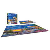 The ROSEART - MY HAPPY PLACE - CAMPER NIGHT 750-piece jigsaw puzzle features an RV at sunset in a scenic outdoor setting with trees and flowers, alongside the displayed puzzle box.