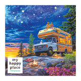 Two people relax on a camper van by a cliff, amidst trees and flowers beneath the stars. A campfire and colorful blankets lie nearby. The ROSEART jigsaw puzzle box says "MY HAPPY PLACE - CAMPER NIGHT - 750 PIECE.