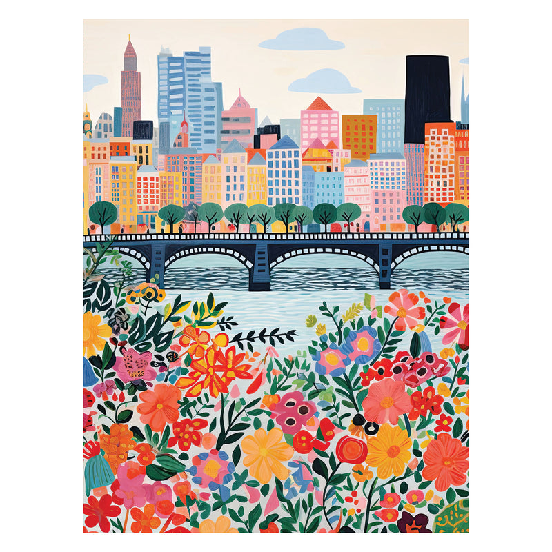 ROSEART - VERTICAL VISIONS - CITY FLOWERS 500 Piece Jigsaw Puzzle features a vibrant city skyline with tall buildings, a river bridge, and colorful flowers in the foreground—perfect for puzzle enthusiasts.