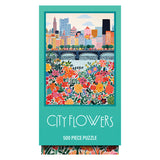 The ROSEART VERTICAL VISIONS CITY FLOWERS 500 piece jigsaw puzzle features a vibrant city flowers illustration with a skyline and bridge in the background.