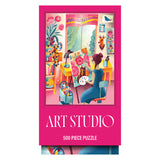 Puzzle box cover features a woman painting flowers in a vibrant studio filled with plants, art supplies, and artworks. Text: "ROSEART - VERTICAL VISIONS - ART STUDIO - 500 PIECE JIGSAW PUZZLE.