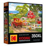 The ROSEART - KODAK PREMIUM - FARM STAND 350 Piece Jigsaw Puzzle features a vibrant farm scene with a red truck, barn, cows, and bustling market stand. With "Richer, Truer Colors," it offers an engaging puzzle-solving experience.