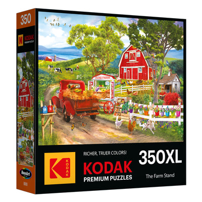 The ROSEART - KODAK PREMIUM - FARM STAND 350 Piece Jigsaw Puzzle features a vibrant farm scene with a red truck, barn, cows, and bustling market stand. With "Richer, Truer Colors," it offers an engaging puzzle-solving experience.