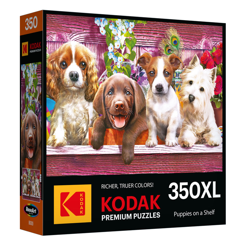 Box of the ROSEART - KODAK PREMIUM 350-piece jigsaw puzzle featuring "Puppies on a Shelf" with puppies on a pink wooden shelf and flowers in the background.