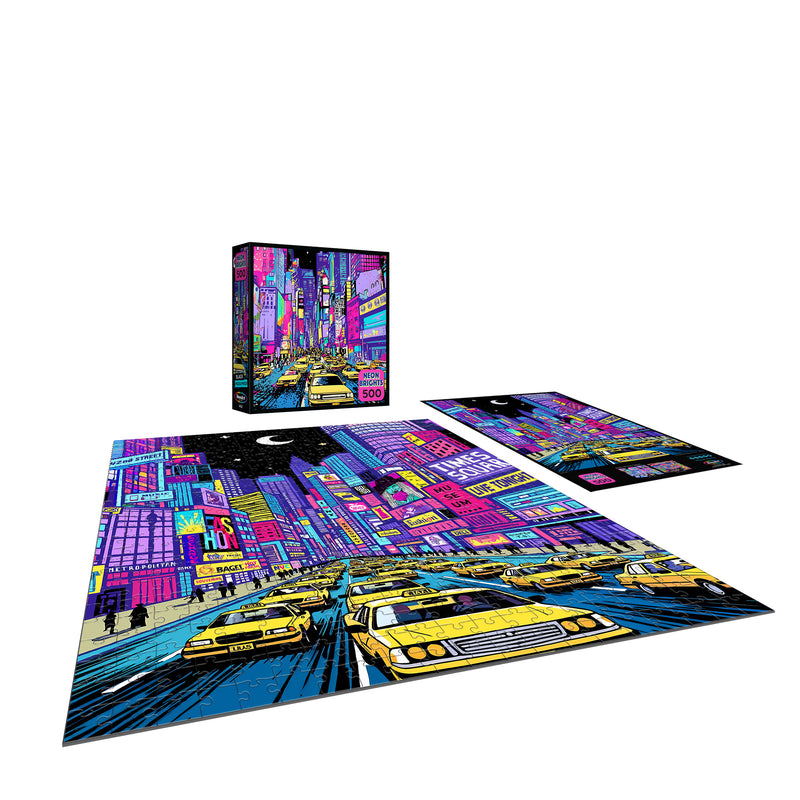 The ROSEART - NEON BRIGHTS - NYC - 500 PIECE JIGSAW PUZZLE features a vibrant nighttime cityscape of NYC with yellow taxis and illuminated skyscrapers.