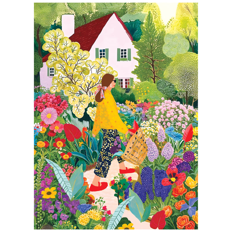 A woman with a basket picks flowers in a vibrant garden near a white house with a red roof—an idyllic scene captured in the ROSEART - SOFT TOUCH - PICKING FLOWERS - 1000 PIECE JIGSAW PUZZLE.