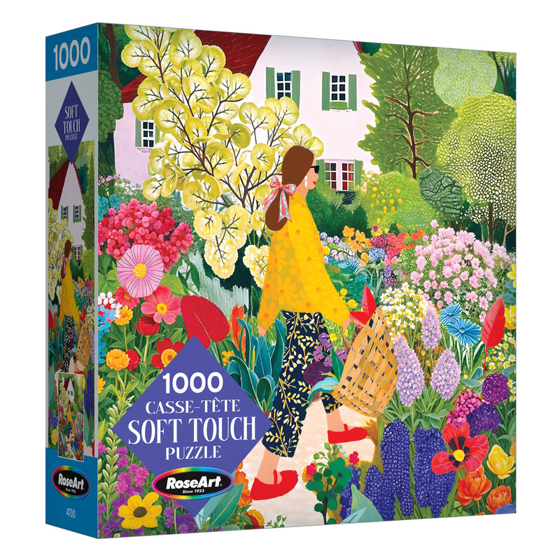 The ROSEART Soft Touch Picking Flowers 1000 Piece Jigsaw Puzzle features an illustration of a woman picking flowers in a vibrant garden before a white house.