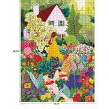 A woman in a yellow top pushes a wheelbarrow through a vibrant flower garden by a white house in the ROSEART Soft Touch Picking Flowers 1000 piece jigsaw puzzle, measuring 26.625" x 19.25".