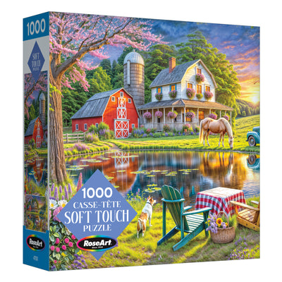 The ROSEART Soft Touch Backyard 1000 Piece Jigsaw Puzzle features a rural spring landscape with a farmhouse, barn, horse, dog, pond, and picnic table.