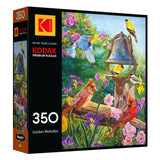 The ROSEART - KODAK PREMIUM "Garden Melodies" 350-piece jigsaw puzzle features colorful birds around a bell in a vibrant garden scene.