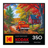 A red vintage truck drives by a red house amid colorful fall trees as a rabbit sits nearby. The box says "ROSEART - KODAK PREMIUM - MAINE ROAD - 350 PIECE JIGSAW PUZZLE.